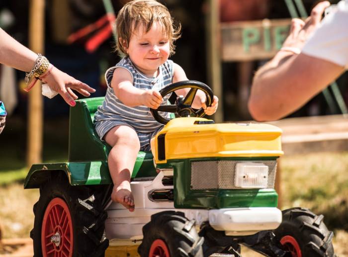 baby riding a tractor toy at ValleyFest